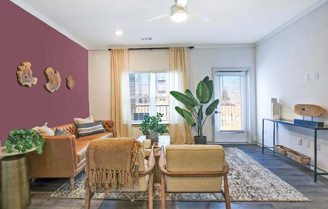 A living room with a brown chair and a brown couch.