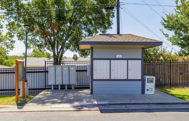 a small building with a lot of mailboxes behind it