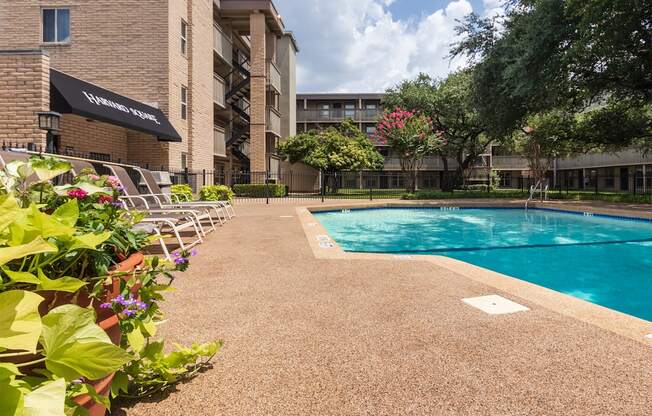 This is a photo of the pool area in the courtyard at Harvard Square Apartments, in the Vickery Meadow neighborhood of Dallas, TX.