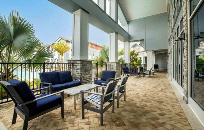 a lobby with tables and chairs and a balcony