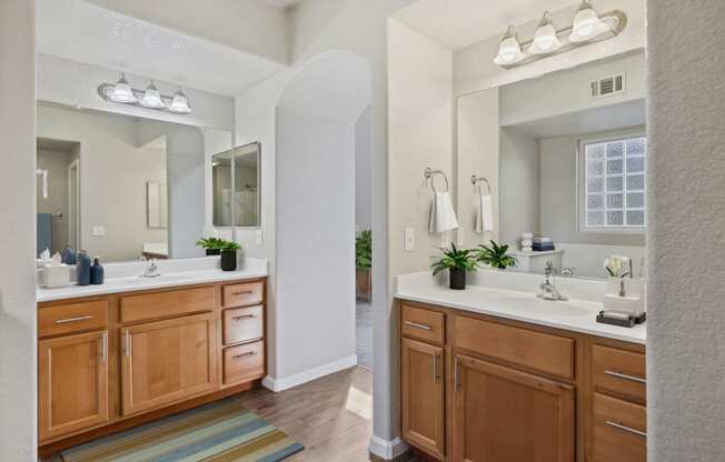 a large bathroom with two sinks and a mirror