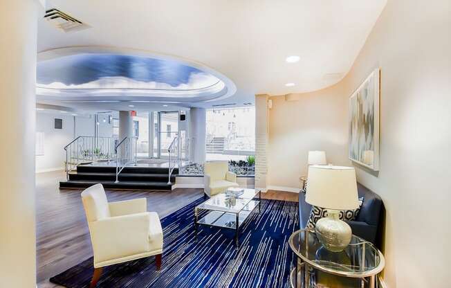 front entrance lobby lounge with social seating, view of front entrance and modern artwork  at hilltop house apartments in columbia heights washington dc