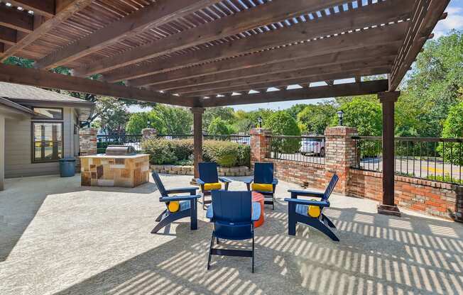 a patio with a pergola and tables and chairs