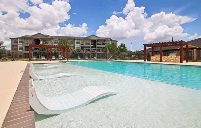 A large swimming pool in front of a building.