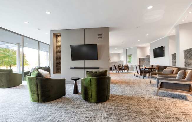 a living room with couches and chairs and a television