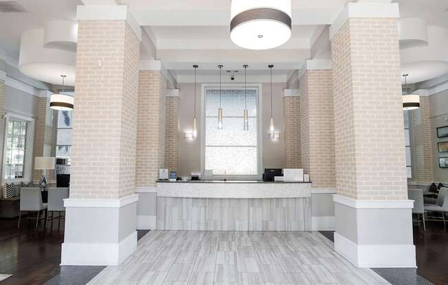 A reception area with a white reception desk and a white ceiling.