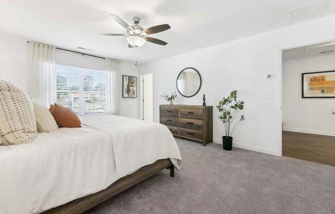 a bedroom with a bed and a ceiling fan