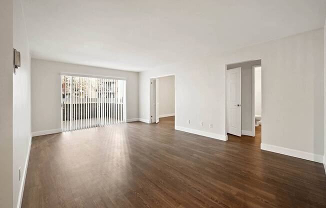 A room with wooden floors and white walls.
