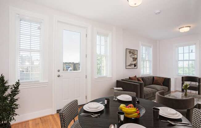 a dining room with a table and chairs and a living room