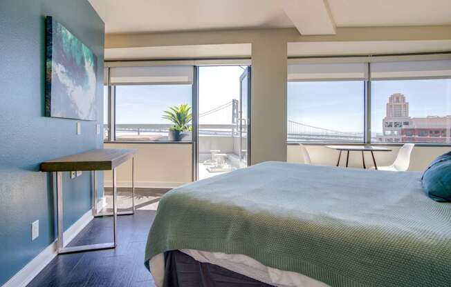 A bedroom with a bed, desk, and chair.