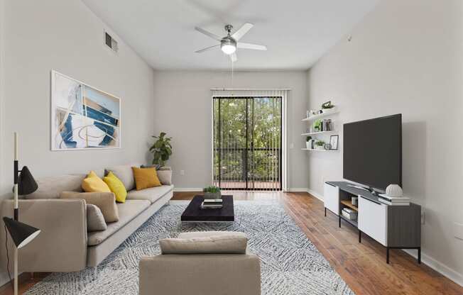 a living room with white walls and a sliding glass door