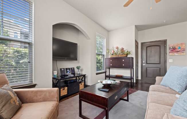 a living room with a couch and a coffee table and a television