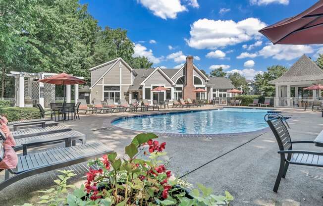 the resort style pool is surrounded by chairs and umbrellas