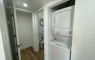 a small bathroom with a washer and dryer in a closet