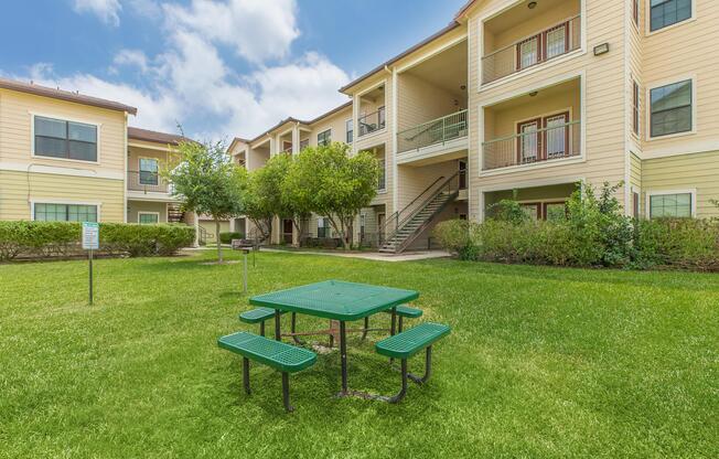 a couple of lawn chairs sitting on a bench in front of a house