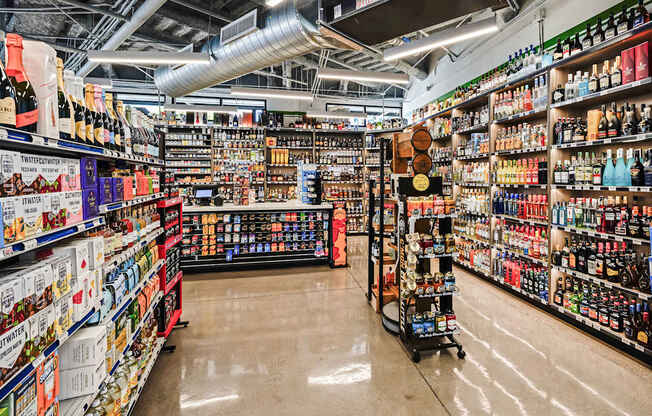 A liquor store with a variety of bottles on the shelves.