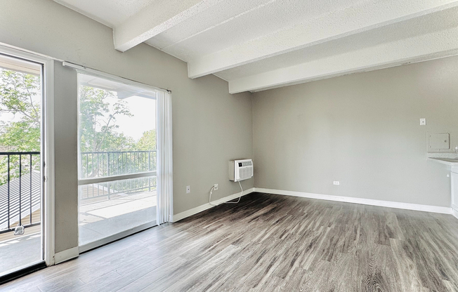 Bright and modern living room featuring stylish plank flooring, fresh two-tone paint, and an open-concept layout—perfect for relaxing or entertaining.