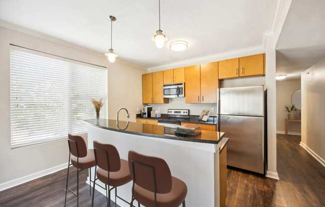 the preserve at ballantyne commons apartment kitchen with island and stainless steel refrigerator