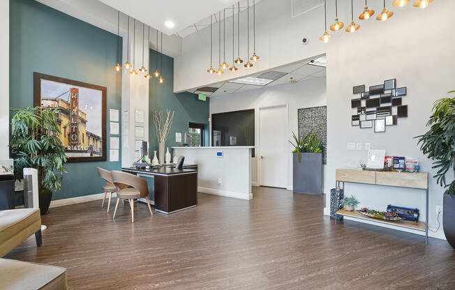A modern office space with a reception desk and a kitchenette.