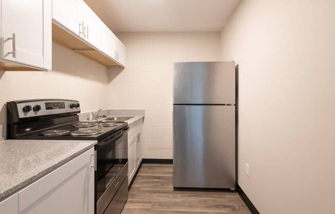 a kitchen with stainless steel appliances and white cabinets