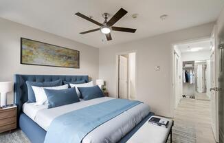 a bedroom with a large bed and a ceiling fan
