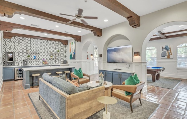 a living room with a couch and a pool table