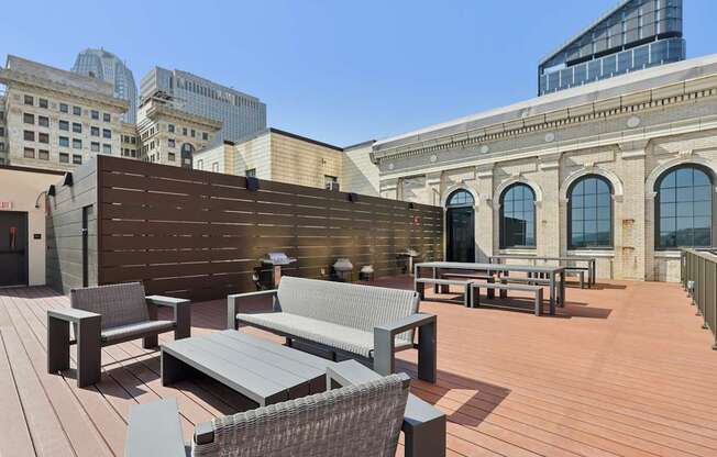 A wooden deck with a bench and a table.