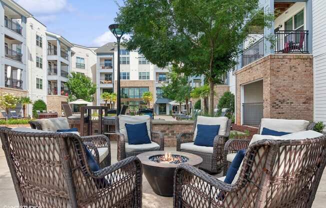 an outdoor patio with chairs and a fire pit