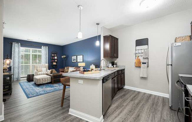 our apartments offer a kitchen and living room with a blue accent wall