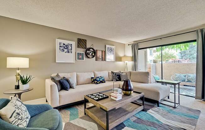 San Jose, CA Apartments- Villas Willow Glen- Wall-to-Wall Carpeting with Sliding Glass Door Leading to Outdoor Patio and Large Sectional Couch