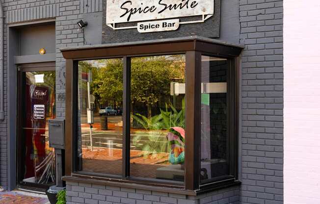 A window with a sign that says Spice Suite Spice Bar.