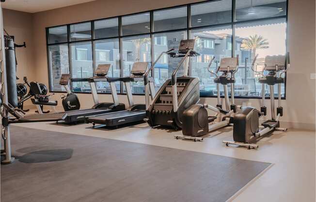 Gym with rowers, stationary bike, treadmills, stair stepper, and ellipticals