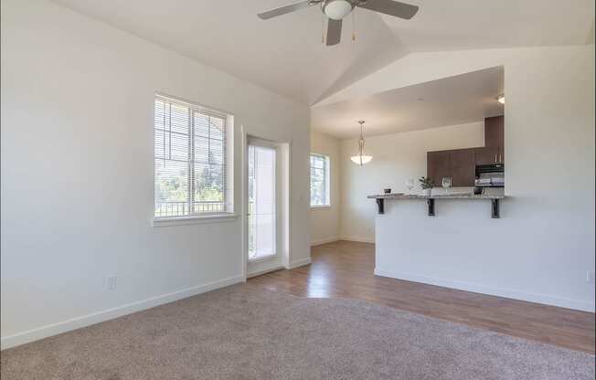 A spacious room with a ceiling fan and a window at Riverplace Apartment Homes, Oregon, 97351