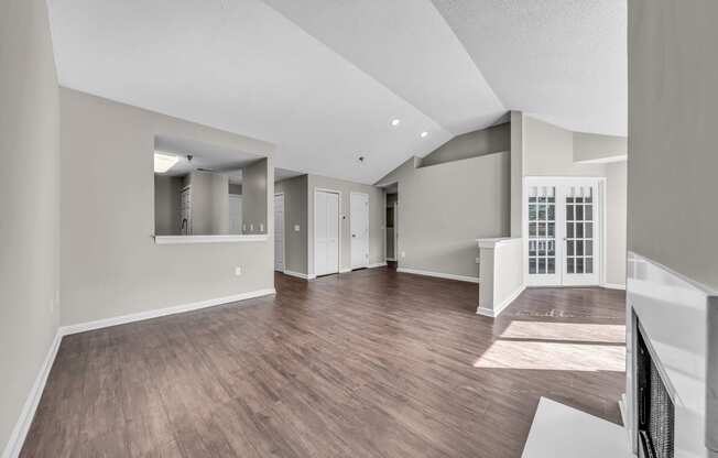 the living room and dining room of a new home with hardwood flooring and