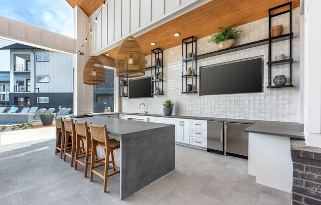 A modern kitchen with a bar area and a balcony.