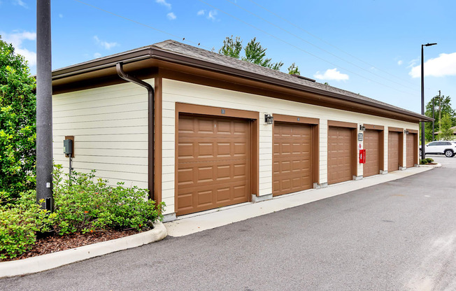 a row of garages with brown doors