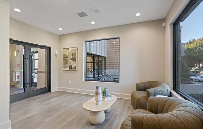 Flatiron West Trade Apartments leasing office with two chairs and a coffee table