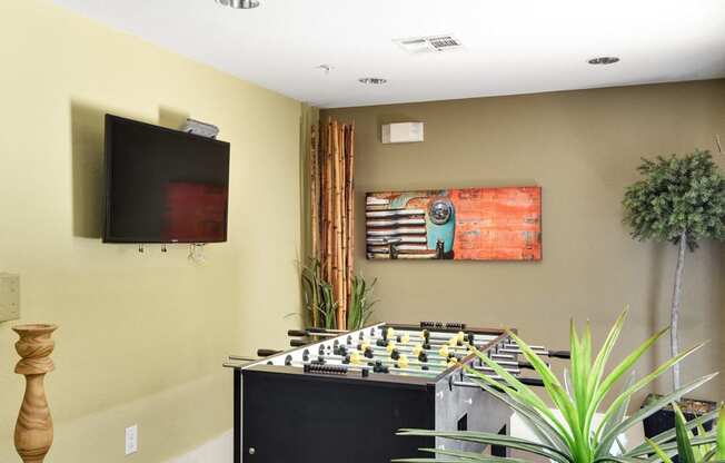 a game room with a chess board and a tv