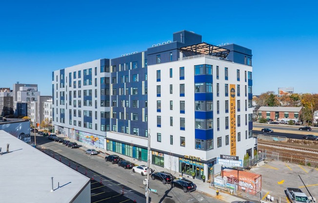 A large white and blue building with a yellow tower on the side.