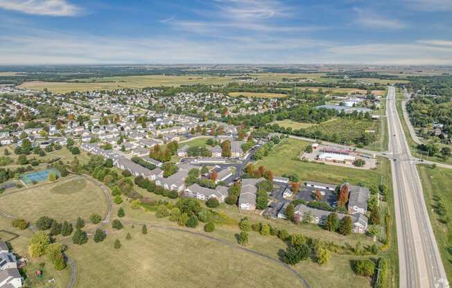 an aerial view of a neighborhood of houses and a highway