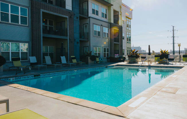 a swimming pool in front of an apartment building