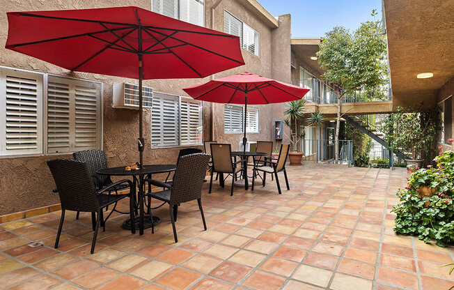 Community courtyard with picnic seating and Spanish tile.