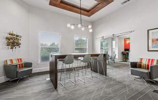 A modern dining room with a wooden table and grey chairs.