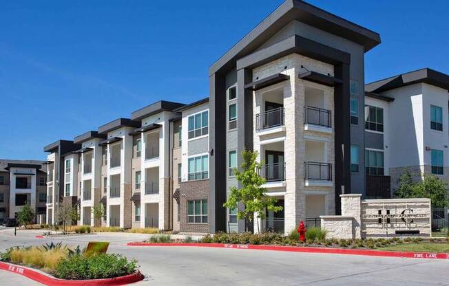 an apartment building with a red curb in front of it at Hunters Creek Apartments, Denton Texas