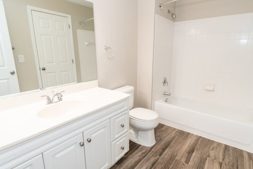a bathroom with a toilet and a tub and a sink at Merion Milford Apartment Homes, Milford, Connecticut