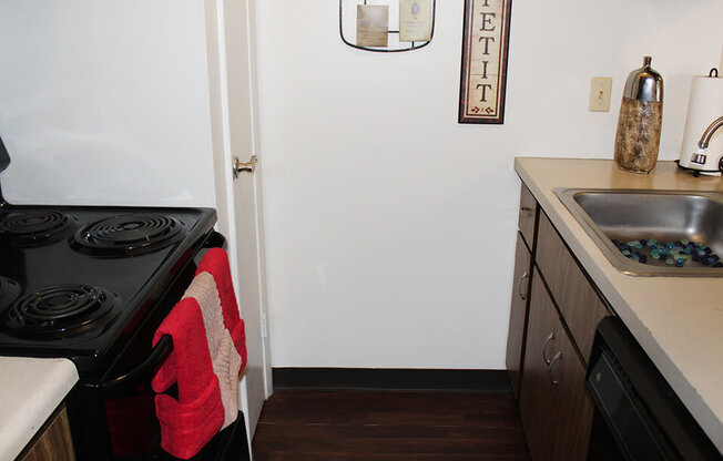 a small kitchen with a stove and sink