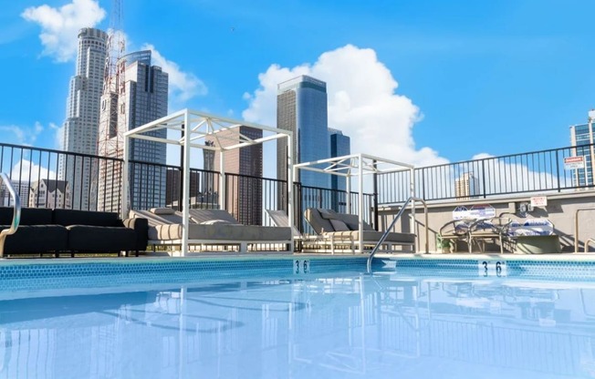 a swimming pool with a city skyline in the background