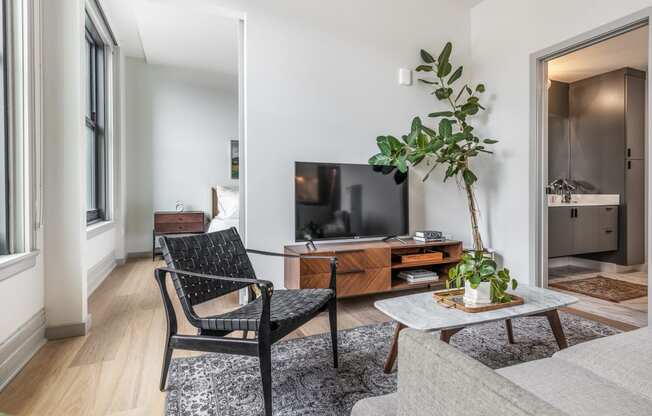 a room with geometric shapes on the wall and a table with a plant at The Commonwealth Building, Pennsylvania