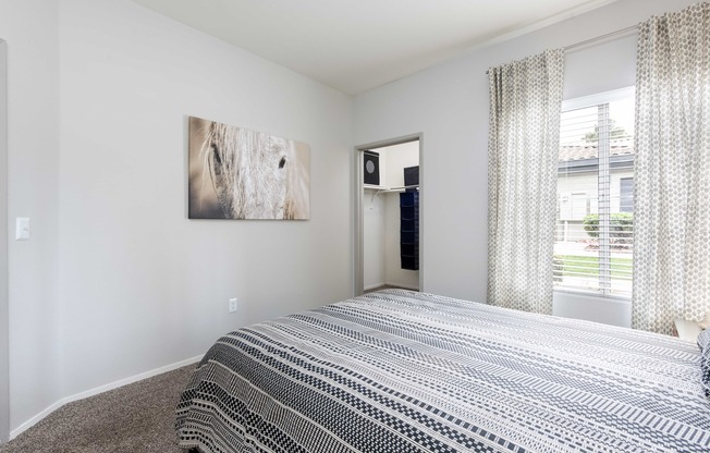 a bedroom with a bed and a window and a closet