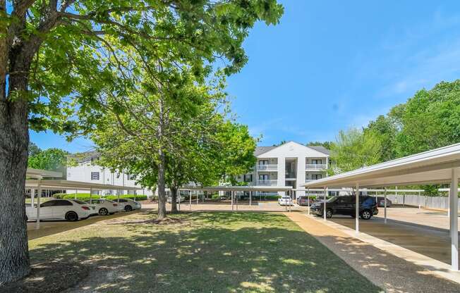 a view of a building with cars parked in a parking lot at Reserve of Jackson Apartment Homes, Jackson, MS